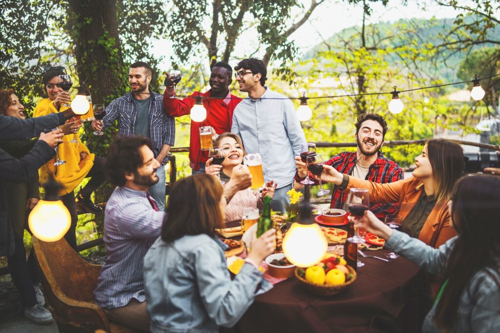 A quiet day with friends toasting together with wine and beer at sunset time, Garden, Italy | SUPERPOBYT World